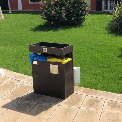 Detalle en zona de exterior ( jardín ) de papelera ecológica de cos compartimentos